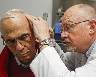        ROBERT K. YOSAY  | THE VINDICATOR..Dr. Eric Hagberg, audiologist, and patient. Hearing Innovations, .Story combines Dr. ERic HagbergÕs effort to gain equal status with chiropractors, dentists, etc. in treating his Medicare patients/ and a mission to China  .Peter Anania  gets his ears checked...by Dr Hagberg..on an annual check up