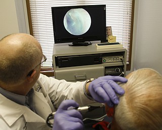        ROBERT K. YOSAY  | THE VINDICATOR..Dr. Eric Hagberg, audiologist, and patient. Hearing Innovations, .Story combines Dr. ERic HagbergÕs effort to gain equal status with chiropractors, dentists, etc. in treating his Medicare patients/ and a mission to China  .Peter Anania  gets his ears checked...by Dr Hagberg..on an annual check up- the monitor is seeing his ear drum .