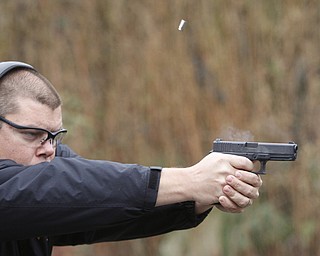        ROBERT K. YOSAY  | THE VINDICATOR..Fraternal Order of Police Lodge 141 set up this firing range for firearms training and qualification for the sheriffÕs deputies it represents off of West Ave.. B. J. Alan Fireworks donated the land and YSU donated the earth for the bullet backstops behind the targets, ..Taking practice is Sgt Steven Lindow..
