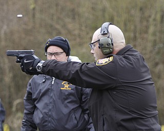        ROBERT K. YOSAY  | THE VINDICATOR..Fraternal Order of Police Lodge 141 set up this firing range for firearms training and qualification for the sheriffÕs deputies it represents off of West Ave.. B. J. Alan Fireworks donated the land and YSU donated the earth for the bullet backstops behind the targets, ..under the watchful eye of Firearms Instructor  Bob Russo Taking practice is Todd Mariani c