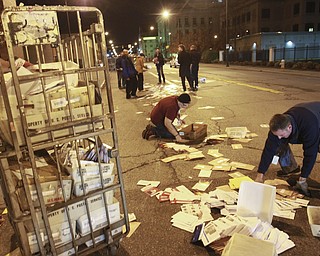 William D. Lewis the Vindicator Postal workers and concerned citizens help clean up a truck load of mail that spilled from a truck on Front St in downtown Y-town Wed. night.