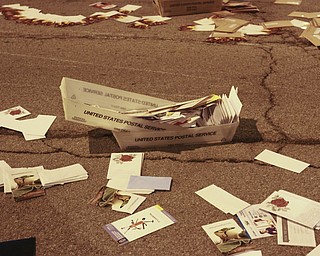 William D. Lewis the Vindicator Postal workers and concerned citizens help clean up a truck load of mail that spilled from a truck on Front St in downtown Y-town Wed. night.