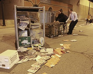 William D. Lewis the Vindicator Postal workers and concerned citizens help clean up a truck load of mail that spilled from a truck on Front St in downtown Y-town Wed. night.