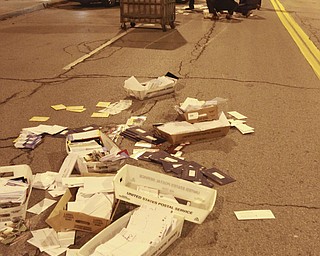 William D. Lewis the Vindicator Postal workers and concerned citizens help clean up a truck load of mail that spilled from a truck on Front St in downtown Y-town Wed. night.