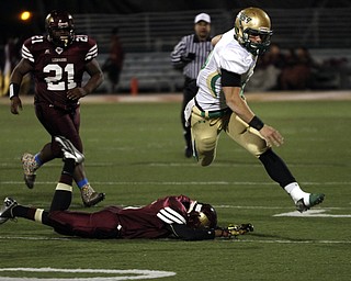  .          ROBERT  K. YOSAY | THE VINDICATOR..Irish #39 Vito Penza leaps over Libertys #5 Dre Rushton on his way to a  first down in second quarter action -..Ursuline Irish vs Liberty Leopards at Mollenkof Stadium...-30-