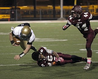  .          ROBERT  K. YOSAY | THE VINDICATOR..Ursulines #39  Vito Penza picks tries to jump over  Libertys #6  Lynn Bowden during second quarter action  as #44  Joe Kangas  runs in..Ursuline Irish vs Liberty Leopards at Mollenkof Stadium...-30-
