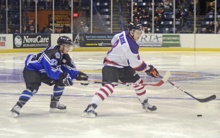 Katie Rickman | The Vindicator.Lincoln Stars Max Humitz (#12) attempts to steal from Phantom's Josh Melnick (#8) during the second period at the Covelli Centre on Sunday, Nov. 16, 2014. Phantoms lost to the Lincoln Stars 3-4 in over time.