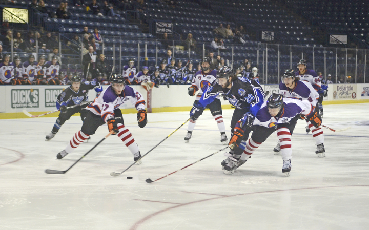 Katie Rickman | The Vindicator.Phantom's Krist Myllari (#27) on left and Conner Yau (#2) attempt to block Lincoln Stars Blake Christensen during the first period at the Covelli Centre on Sunday, Nov. 16, 2014. Phantoms lost to the Lincoln Stars 3-4 in over time.