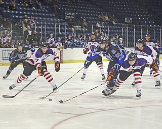 Katie Rickman | The Vindicator.Phantom's Krist Myllari (#27) on left and Conner Yau (#2) attempt to block Lincoln Stars Blake Christensen during the first period at the Covelli Centre on Sunday, Nov. 16, 2014. Phantoms lost to the Lincoln Stars 3-4 in over time.