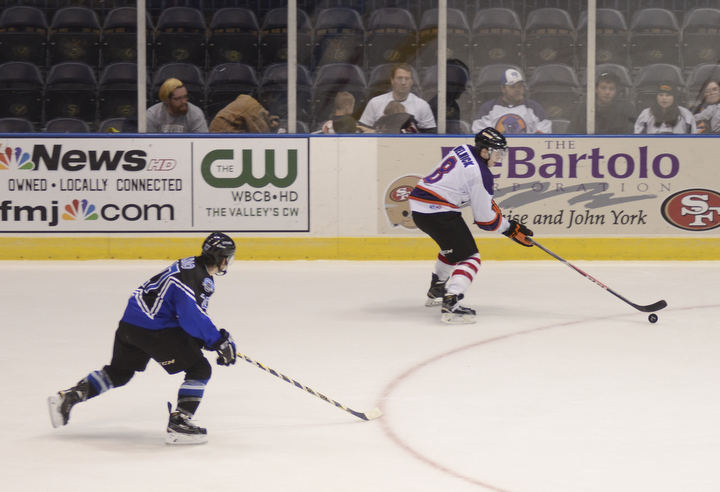 Katie Rickman | The Vindicator.Phantom's Josh Melnick gains control of the puck during overtime as Lincoln Stars Patrick Polino follows close behind at the Covelli Centre on Sunday, Nov. 16, 2014. Phantoms lost to the Lincoln Stars 3-4 in over time.