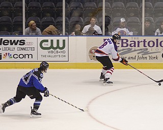 Katie Rickman | The Vindicator.Phantom's Josh Melnick gains control of the puck during overtime as Lincoln Stars Patrick Polino follows close behind at the Covelli Centre on Sunday, Nov. 16, 2014. Phantoms lost to the Lincoln Stars 3-4 in over time.