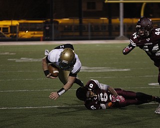  .          ROBERT  K. YOSAY | THE VINDICATOR..Ursulines #39  Vito Penza picks tries to jump over  Libertys #6  Lynn Bowden during second quarter action  as #44  Joe Kangas  runs in..Ursuline Irish vs Liberty Leopards at Mollenkof Stadium...-30-