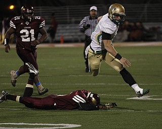  .          ROBERT  K. YOSAY | THE VINDICATOR..Irish #39 Vito Penza leaps over Libertys #5 Dre Rushton on his way to a  first down in second quarter action -..Ursuline Irish vs Liberty Leopards at Mollenkof Stadium...-30-
