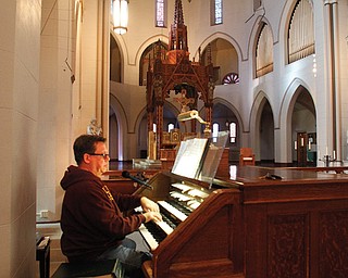 Kris Harper, music director at St. Patrick Church in Youngstown, plays the Votteler-Holtkamp-Sparling organ that was donated to the Catholic parish by John Knox Presbyterian Church, which closed last year. A dedication concert will be at 2 p.m. Sunday.