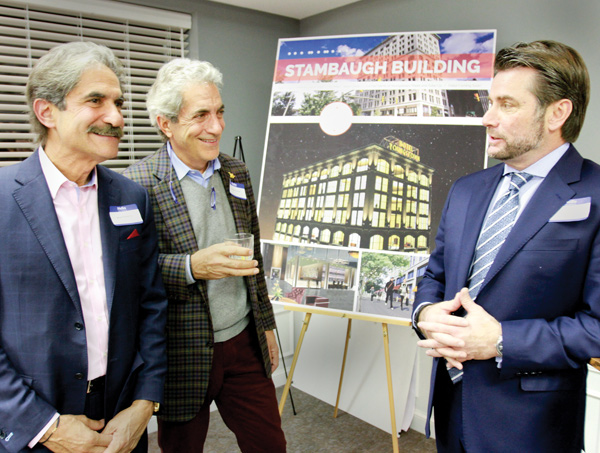 Brothers and developers James, left, and George Pantelidis and Dominic J. Marchionda of NYO Property Group discuss the plans for a hotel in downtown Youngstown at the First National Bank Building. The collaborators announced Wednesday that Marshall Hotels and Resorts Inc. will operate the building as DoubleTree Hotel, a Hilton brand.