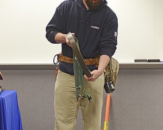 Katie Rickman | The Vindicator.Brandon Bernhard of Champion works for Ohio Edison- he shows off some of the gear that linemen wear during a training demonstration at Kent State University Trumbull campus on Friday, Nov. 14, 2014.