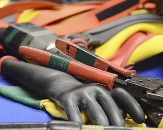 Katie Rickman | The Vindicator.Rubber gloves and line cutters on display during a training demonstration at Kent State University Trumbull campus on Friday, Nov. 14, 2014.