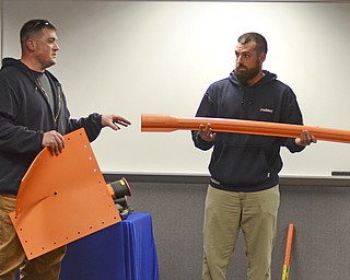 Katie Rickman | The Vindicator.Two Ohio Edison workers Brandon Durig, left, of Niles and Brandon Bernhard of Champion show different gear that linemen use during a training demonstration at Kent State University Trumbull campus on Friday, Nov. 14, 2014.