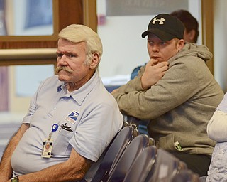 Katie Rickman | The  Vindicator.Two local postal workers Tom Harrison of Canfield, on left and Brian Furbee of Youngstiown attend the American Postal Workers press conference on Friday, Nov. 14, 2014.