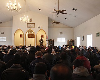 Members of the community bow down during a prayer service at the funeral of Abdullah Nagi Mahdi at the Islamic Society of Greater Youngstown on Friday, Nov. 21, 2014 at  Masjid Al-Khair in Youngstown. Mahdi was killed earlier this week during an attempted robbery at his South Avenue store.