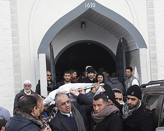  Men carry out the body of Abdullah Nagi Mahdi from the Islamic Society of Greater Youngstown on Friday, Nov. 21, 2014 at Masjid Al-Khair in Youngstown following the funeral service. Mahdi was killed earlier this week during an attempted robbery at his South Avenue store.