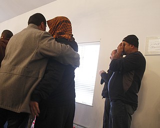 Men embrace during the funeral of Abdullah Nagi Mahdi at Masjid Al-Khair where members of the community attended the funeral on Friday, Nov. 21, 2014. Mahdi was killed earlier this week during an attempted robbery at his South Avenue store.
