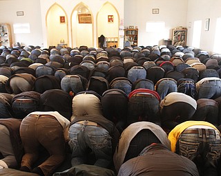 Members of the community bow down during a prayer service at the funeral of Abdullah Nagi Mahdi at the Islamic Society of Greater Youngstown on Friday, Nov. 21, 2014 at Masjid Al-Khair in Youngstown. Mahdi was killed earlier this week during an attempted robbery at his South Avenue store.