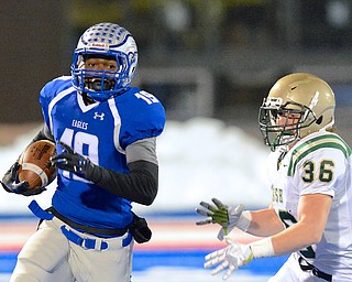 Jeff Lange | The Vindicator  Hubbard's Isaiah Scott (19) runs past SVSM's Patrick Oliverio during early first quarter action in their regional final matchup in Ravenna, Friday night.