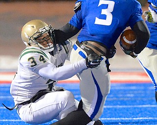 Jeff Lange | The Vindicator  Akron St. Vincent-St. Mary defensive lineman Dre'k Brumley (34) brings down Hubbard running back L.J. Scott in the backfield during third quarter action of their 26-23 victory over the Hubbard Eagles, Friday night in Ravenna.