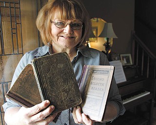 ROBERT  K. YOSAY | THE VINDICATOR  Shirley Eckley of Hubbard, a descendant of William Holmes McGuffey who loves to teach, holds several of the McGuffey Readers she owns.