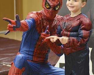 Katie Rickman | The Vindicator.Zion Day, 4, of Canfield poses with spiderman while his mother Amanda takes a photo at the Mom and Son Date Knight at Boardman Park, Nov. 15, 2014.