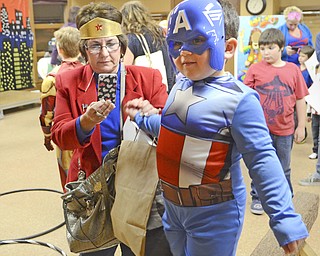 Katie Rickman | The Vindicator.Angela Procopio of Canfield steps in as Wonder Woman for the night with her grandson Ethan Procopio, 4 - she helps him balance on a balancing beam at the Mom and Son Date Knight at Boardman Park, Nov. 15, 2014.