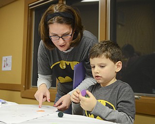 Katie Rickman | The  Vindicator.Jack Martin Cochran, 4, decorates a shield with his mother Maria Cochran, both of Boardman at the Mom and Son Date Knight at Boardman Park, Nov. 15, 2014.