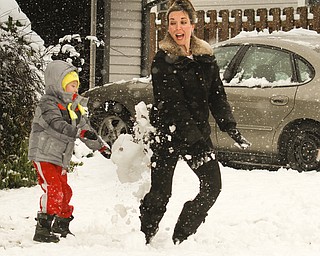        ROBERT K. YOSAY  | THE VINDICATOR...Here comes winter as  Zachary 5, and Sheri Hufnagel play in the snow making snow man .. snow angels and just general fun as the first good snowfall fell overnight.