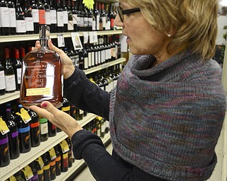 Katie Rickman | The Vindicator.Joyce D'Amico, holds a bottle of to show the style of label-etching that will be offered at the North Lima Location December 4, 2014 from 4-7.