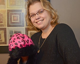 Katie Rickman | The Vindicator.Lisa Weimer holds up one of the many hats that was donated to her to give away on Wednesday, Nov. 19, 2014.