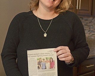 Katie Rickman | The Vindicator.Lisa Weimer holds up an article written about her at her Poland home on Wednesday, Nov. 19, 2014.