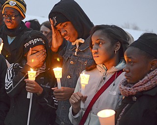 Katie Rickman | The Vindicator.L-R.Savannah Sockwell, 17, Taeshauna Moore, 16, Clemont Fowler, 17, Laynziah Johnson 16, and Precious Boone, 17  stand together at the vigil for Faith McCullough Wooster on Wed. November 19, 2014.