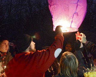 Katie Rickman | The Vindicator.Maximus McCullough stands next to his son Harley McCullough as they light a lantern at the vigil for Faith McCullough-Wooster on Wednesday, Nov. 19, 2014.