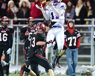 AKRON, OHIO - NOVEMBER 22, 2014: Joe Falasca #11 of Reserve goes up to catch a pass over Sam Carper #13 of Norwalk St. Paul during the first half of Saturday nights playoff game at Copley High School. (Photo by David Dermer/Youngstown Vindicator) He would be called for a 15 yard penalty for saluting the crowd after the play.