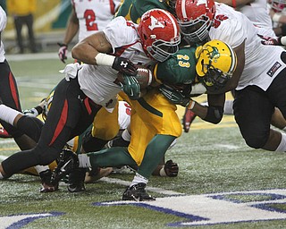 Youngstown State's Derek Rivers (11) tries to strip the ball from North Dakota State running back John Crockett (23) during the second quarter of Saturday afternoons matchup at the Fargodome in North Dakota.  Dustin Livesay  |  The Vindicator  11/22/14  Fargo, North Dakota.
