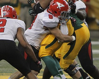 Youngstown State's Donald D'Alesio (8) wraps up North Dakota State running back John Crockett (23) during the second quarter of Saturday afternoons matchup at the Fargodome in North Dakota.  Dustin Livesay  |  The Vindicator  11/22/14  Fargo, North Dakota.