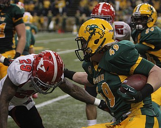 Youngstown State's Martin Ruiz (29) powers his shoulder to make a tackle on North Dakota State's Nick DeLuca (49) during an interception return during the second quarter of Saturday afternoons matchup at the Fargodome in North Dakota.  Dustin Livesay  |  The Vindicator  11/22/14  Fargo, North Dakota.