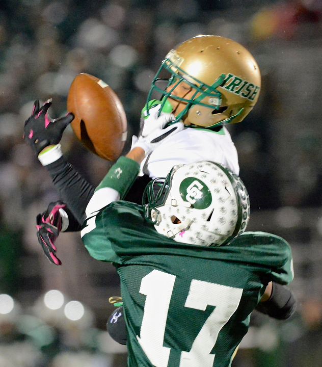 Jeff Lange | The Vindicator  Ursuline wide receiver David Collins (top) drops a pass as he is brought down at the facemask by Crusaders' defender John Colangelo (17) during first half regional finals action in Uniontown, Saturday evening.