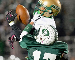 Jeff Lange | The Vindicator  Ursuline wide receiver David Collins (top) drops a pass as he is brought down at the facemask by Crusaders' defender John Colangelo (17) during first half regional finals action in Uniontown, Saturday evening.