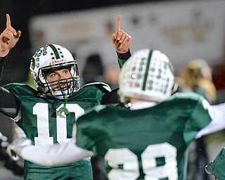 Jeff Lange | The Vindicator  Crusaders' quarterback Jake Boccuti (left) shows the crowd who's number one after a second half touchdown. Canton went on to beat the Irish 20-6 capturing the regional title, Saturday evening.