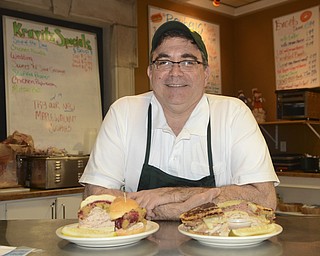 Katie Rickman | The Vindicator.Jack Kravitz poses for a photo in the Kravitz Deli at Poland Village Library with two of his sandwiches on Thursday Nov. 20, 2014.