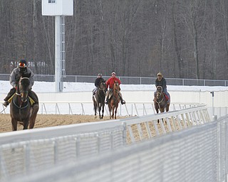        ROBERT K. YOSAY  | THE VINDICATOR..Jockeys and horses reverse the direction as they pony their horses and also for cooling them down after a training session..Hollywood Gaming /Mahoning Valley Race Course is in the final hours of preparation for Mondays first race with a post time of 12:45 on Monday ..-30-