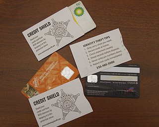        ROBERT K. YOSAY  | THE VINDICATOR.. Sheriff Jerry Greene inserting a credit card into a protective sleeve to prevent RFID skimming. The sheriffÕs office is giving two free sleeves to anyone who wants them to prevent identity theft. TheyÕre funded by drug forfeiture money...-30-