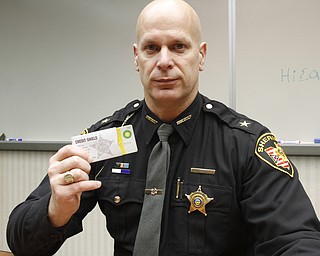       ROBERT K. YOSAY  | THE VINDICATOR.. Sheriff Jerry Greene inserting a credit card into a protective sleeve to prevent RFID skimming. The sheriffÕs office is giving two free sleeves to anyone who wants them to prevent identity theft. TheyÕre funded by drug forfeiture money...-30-